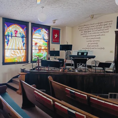 Sanctuary with pews and stained glass windows