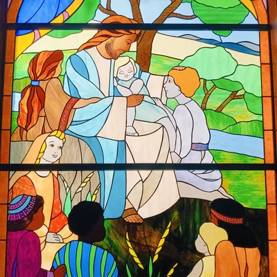 Stained glass depicting Jesus with children